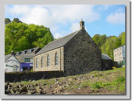 View of opposite side of church taken from foreshore. The low wall in front of the church surrounds a grassed area.